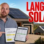 Ray holding a utility bill and solar quote in front of a Langley home with rooftop solar panels